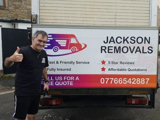 Jackson Removals box van with its new rear graphics, thumbs up beside it