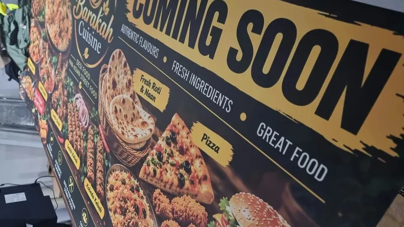 Coming Soon banner printed for Barakah Cuisine, desi and pan-Asian street food, with a gold headline, the logo and photos of kebabs, naan, pizza and burgers