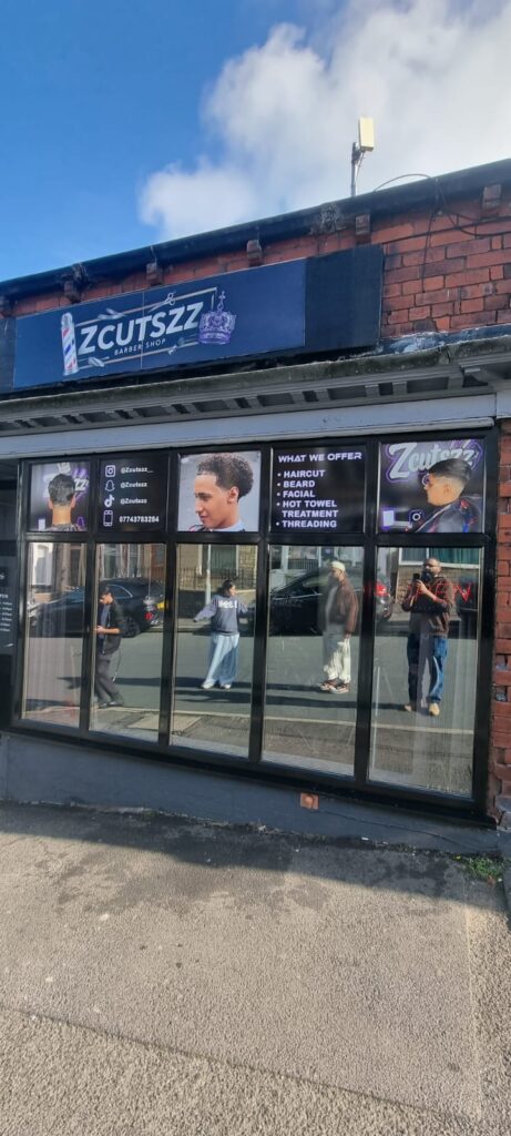 Zcutszz barbershop shopfront with fascia sign and printed window panels