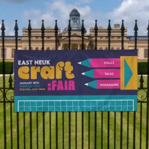 1.5m x 1m PVC Banner: printed craft fair banner on black railings in front of a park