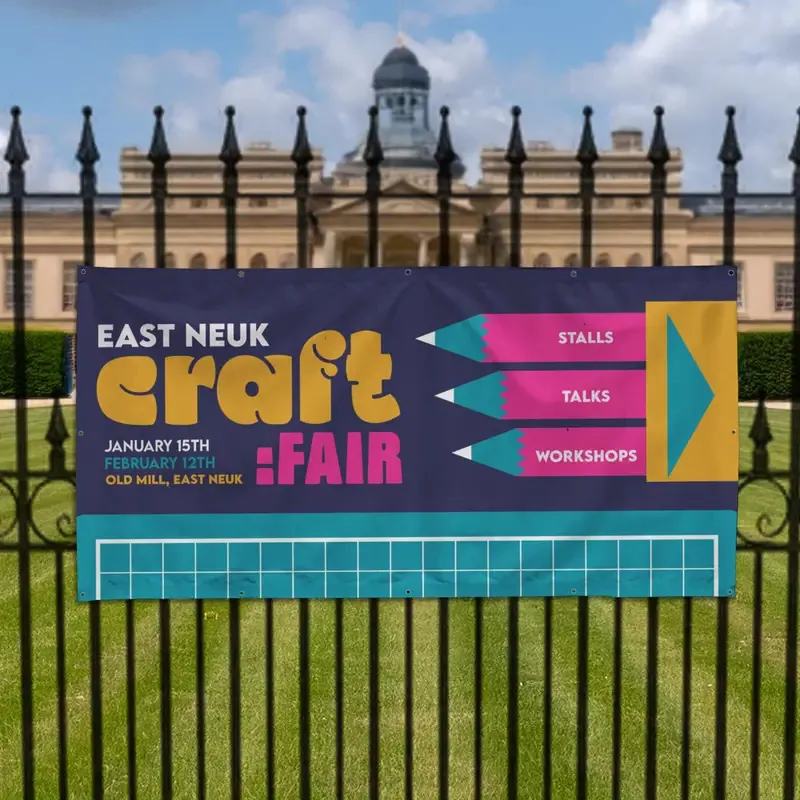 1.5m x 1m PVC Banner: printed craft fair banner on black railings in front of a park
